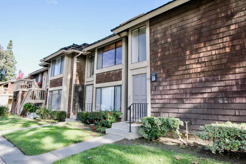 A beautiful day in the Sutter Creek Townhomes with a house and flag.