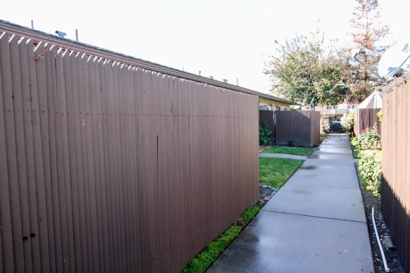 A fence surrounding a green lawn in The Pines neighborhood of Anaheim