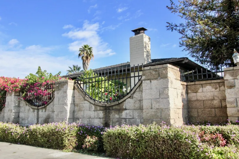 Outside the Compound wall of villa in The Pines has flowers in the bushes