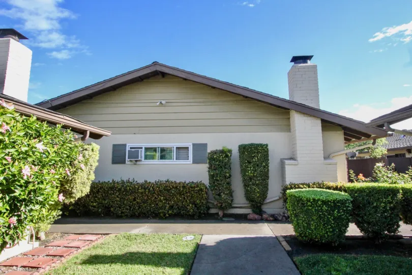 Nice green lawn with small plants in front of a villa in The Pines of Anaheim