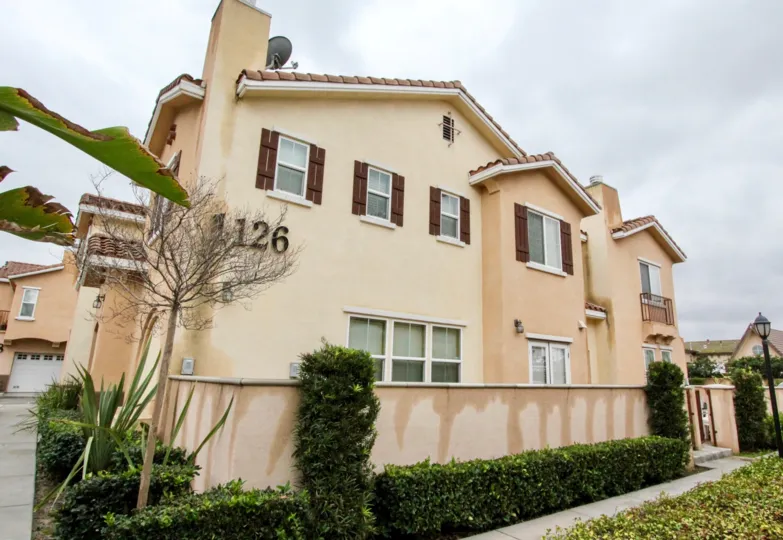 A home and exterior wall and landscaping in the Villa de Euclid community in Anaheim