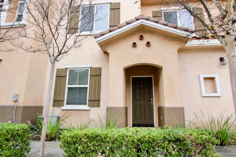 The front door to a tan adobe home in the community of Villa de Euclid in Anaheim, California