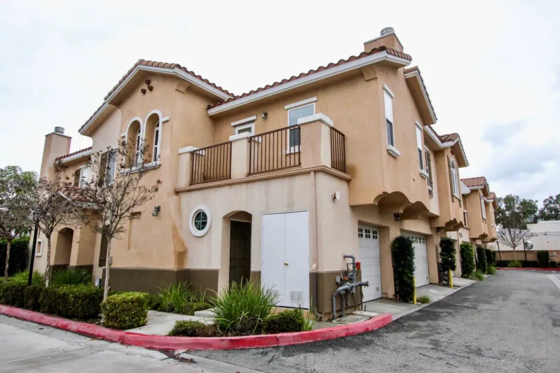 THIS IMAGE SHOWS THE FLAT UNDER THE SHEDS, ON THE FRONT SMALL PLANTS, ROADWAY, PALCONY ARE THERE IS IN ANAHEIM CITY