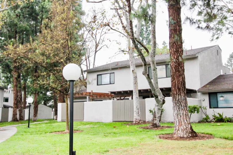THE FRONT VIEW HOUSE WITH LAWN, TREES, PLANTS, LAMP ARE THERE WHICH IS IN VILLA FRONTERA