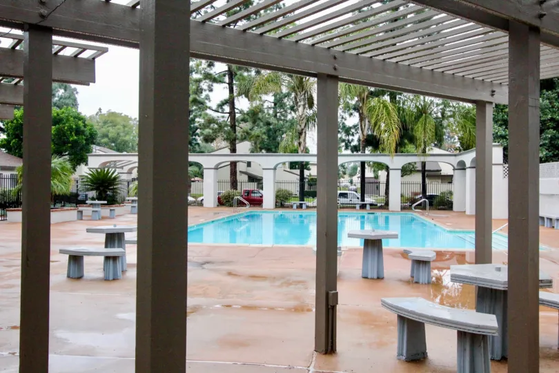 A small swimming pool in the Villa Frontera with some chairs.
