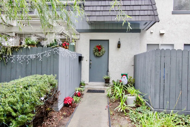 A house in Village Green main door decorated with bookie and both sides of the door entrance is well planted with flower plants