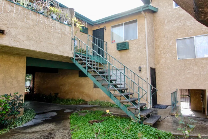 A stair case in Webster Heights with an old building.
