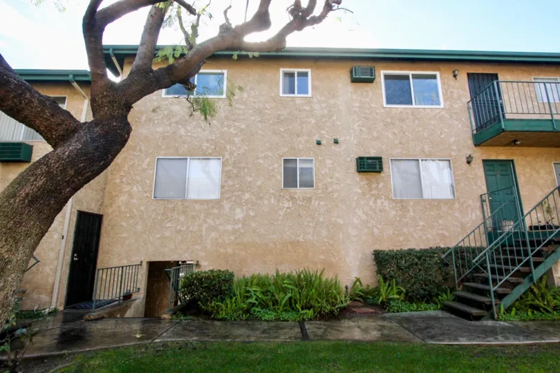 THE HOUSE WITH LAWN, PLANTS, STEPS, GLASS WINDOWS, PALCONY ARE SHOWN IN WEBSTER HEIGHTS COMMUNITY