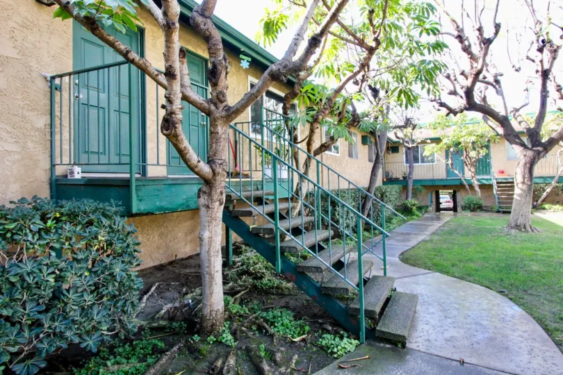 THE VILLAS WHICH HAVE THE STEPS TO ENTER, LAWN, PLANTS, TREES IN ANAHEIM CITY