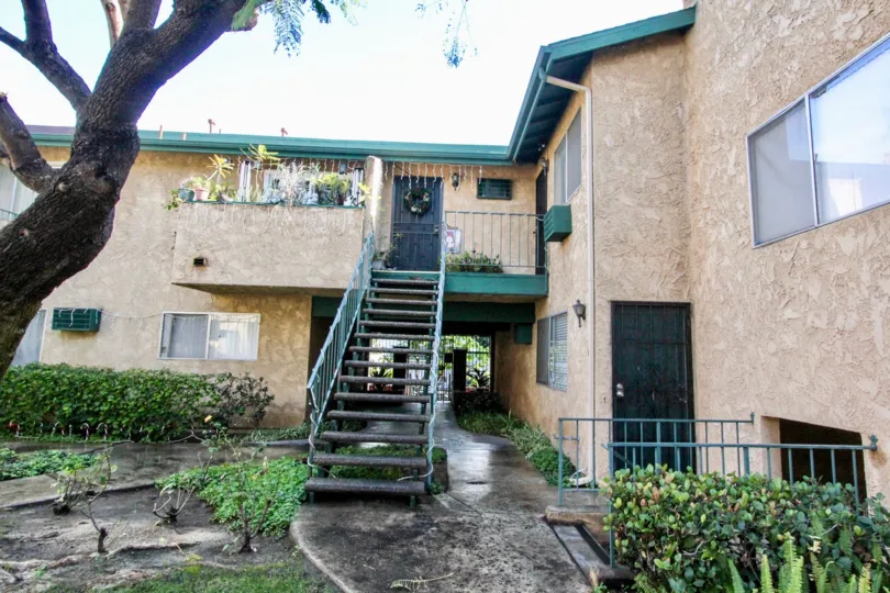 THIS IMAGE VIEWS THE PATHWAY TO THE HOME BY STEPS, NEARBY PLANTS TREES ARE THERE IN ANAHEIM CITY