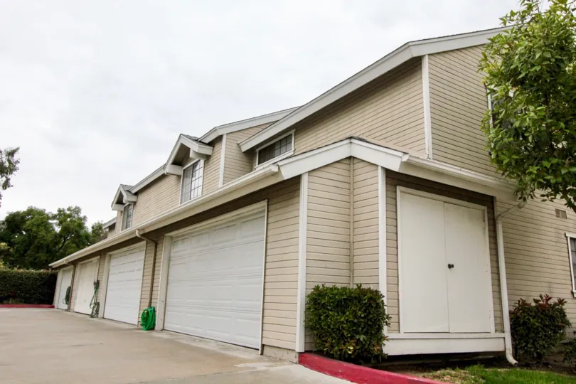 THIS IMAGE SHOWS THE HOUSE UNDER THE SHEDS, ON EACHSIDE PLANTS, TREES ARE THERE IN ANAHEIM CITY