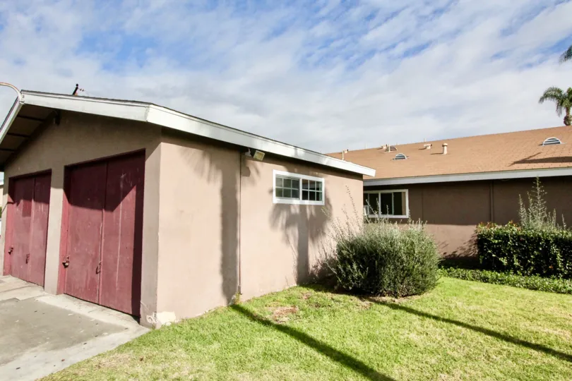 A home and garage viewed from the front yard on a sunny day in the Westwood Village community