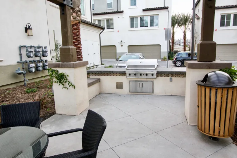 An outdoor common area with a BBQ grill in the Aldea Walk community