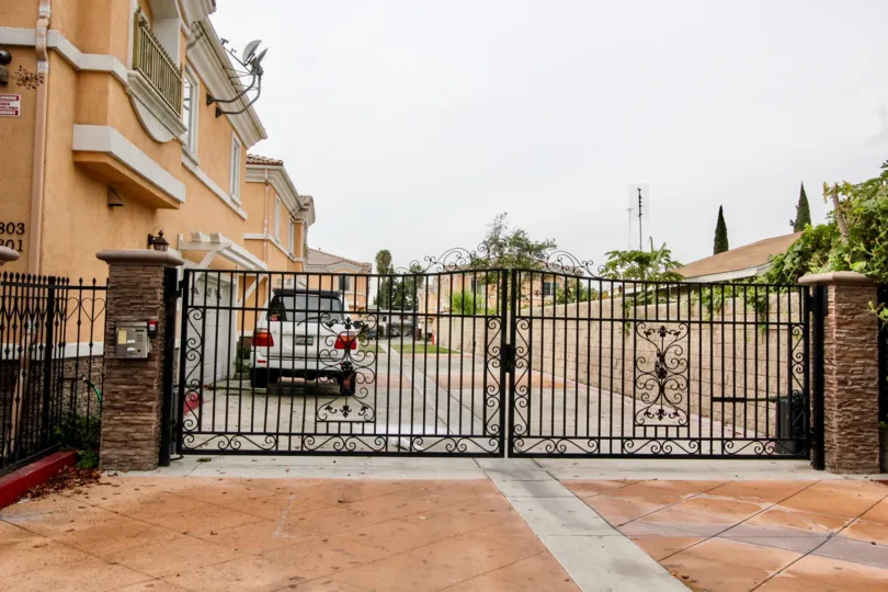 THIS IS THE GATEWAY TO THE APARTMENTS, INSIDE THE CAR IS THERE, PLANTS, TREES ARE SHOWN IN BUENA PARK CITY