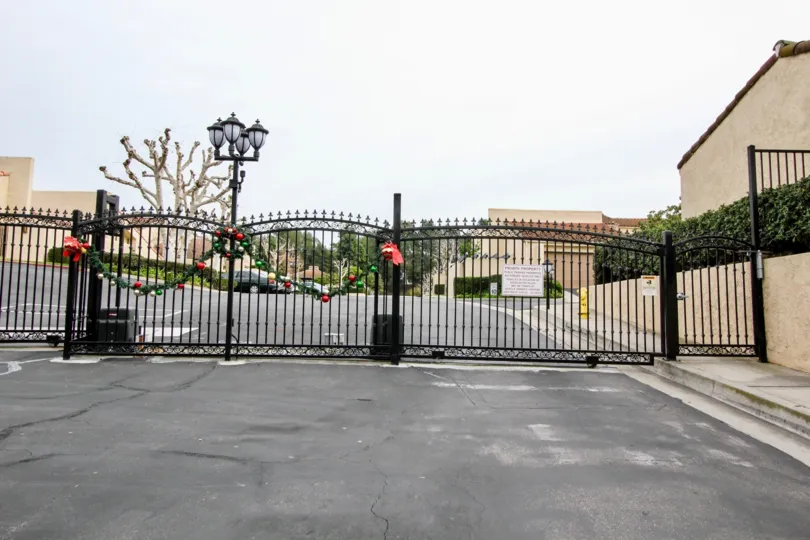 a rainy day in the buena tierra with a building that has lamp light in front and entrance gate closed