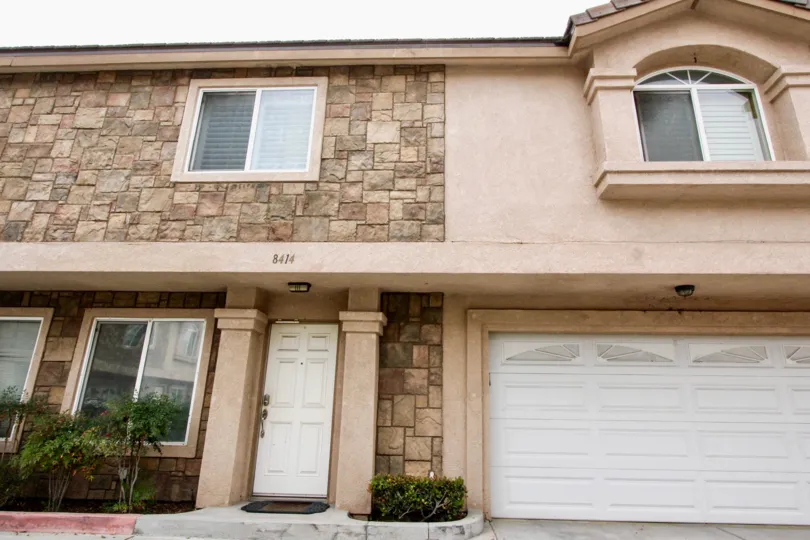 a pleasant day in the buena villa townhomes with a house that has numbered as 8414 and has closed parking door