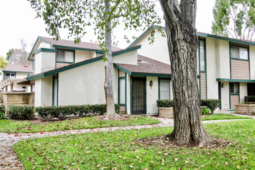 THIS IMAGE REPRESENTS THE HOUSE WITH BEAUTIFUL LAWN, PATHWAY TO ENTER, TREES, CROTONS ARE THERE IN BUENA PARK