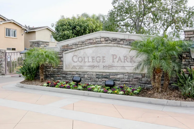 THIS IMAGE SHOWS THE ENTRANCE WAY WITH NAME BOARD LOCATED IN BUENA PARK ON THE FRONT PLANTS ARE THERE