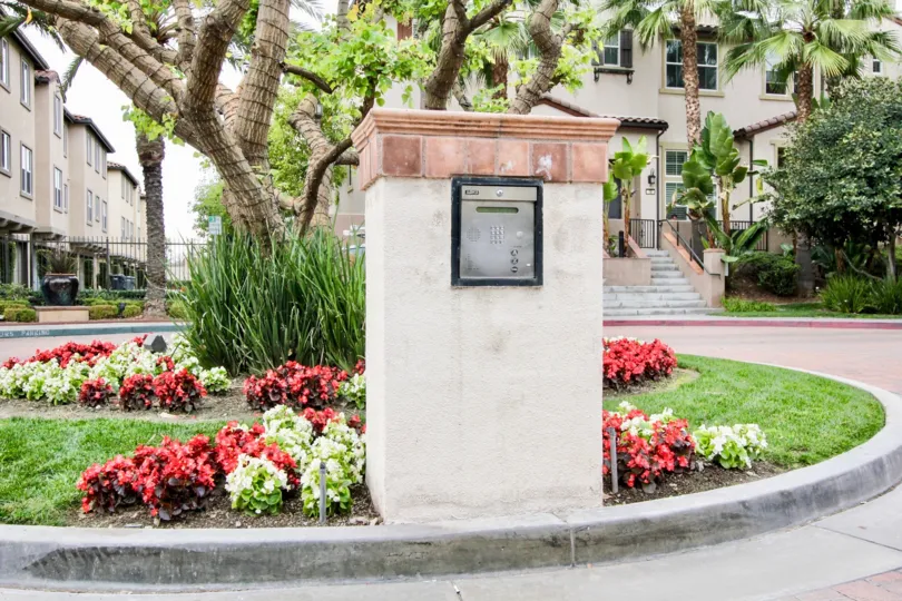 Marvellous view of flower garden in front of villa with trees in Founders Walk of Buena Park