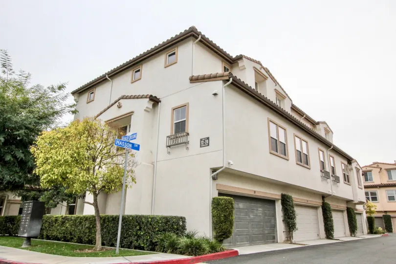 THE LARGE HOUSE IN BUENA PARK THAT SHOWS THE NAME BOARD, TREES, PLANTS, AND SHED FOR EACH