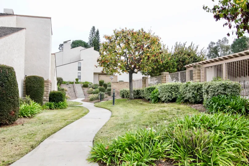 THIS IMAGE REPRESENTS THE PATHWAY TO THE HOME ON THE BOTHSIDE LAWN WITH PLANTS ARE THERE IN BUENA PARK