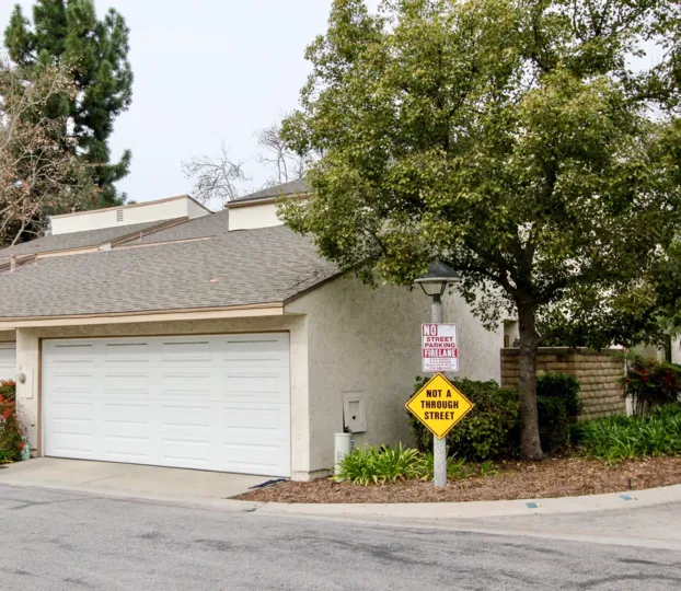 THIS IMAGE SHOWS THE SHED WITH PLANTS, TREES, NAME BOARD LOCATED IN BUENA PARK
