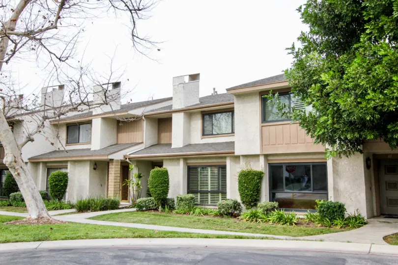 THE FLATS WITH FRONT VIEW MANY PLANTS, TREES, PATHWAY TO ENTER IS LOCATED IN BUENA PARK