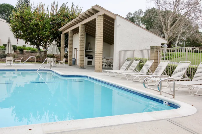 The pool and lounge chairs and at the Los Coyotes Village community