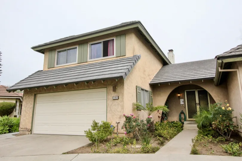A old age home in meadowbrook with beautiful front entrance and shed, plants, flowers.