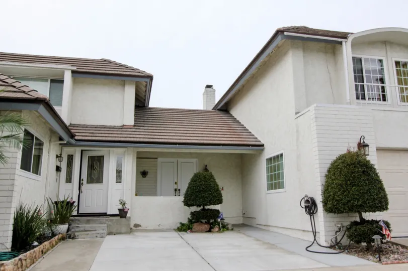a rainy day in the meadowbrook with a house that has roofless top and garden in front and white door