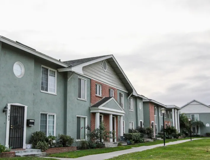 The Apartment in Monticello Townhomes with street lamps, plants and cutted bushes