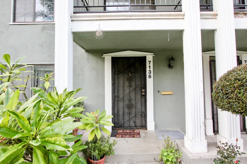a pleasant day in the monticello townhomes with a house that has numbered as 7136 and garden in front