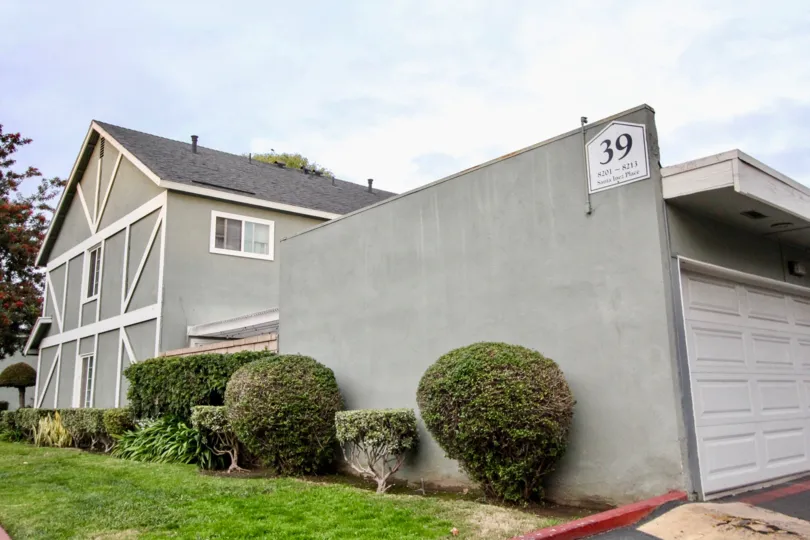a pleasant day in the monticello town homes with a building that has parking door closed and garden around