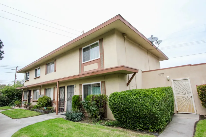 Near the door of the Home in Valley view Villas has cutted bushes with meadows and dish antenna is connected at terrace