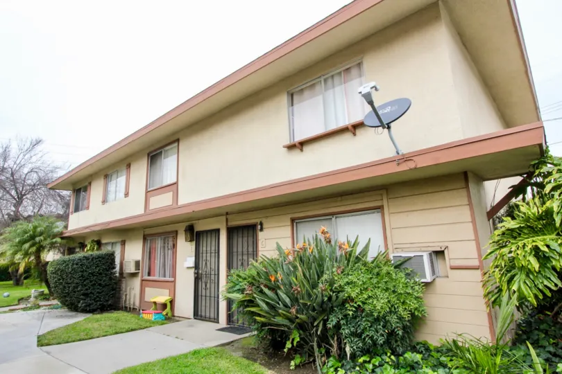 a rainy day in the valley view villas with house that has dish antenna and windows on ac and garden in the front