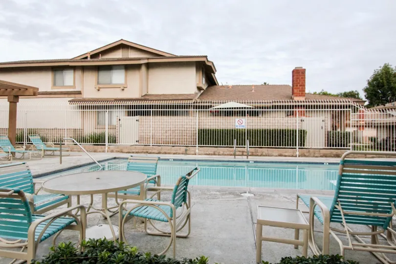 Nice view of swimming pool with chairs near villas in Village park of Buena Park