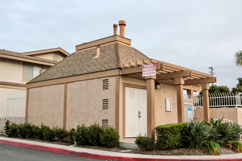 A beige painted house bearing a private property sign in the Village Park of Buena Park, CA