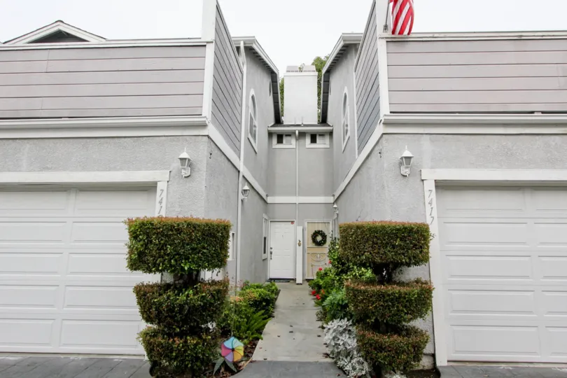 THE 7417 FLAT IN THE WESTERN BAY ESTATES WITH THE PLANTS, SHUTTERS, FLAG