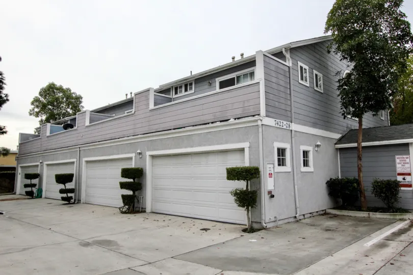 THE 7422-28 FLATS IN THE WESTERN BAY ESTATES WITH THE SHUTTERS, PLANTS, TREES
