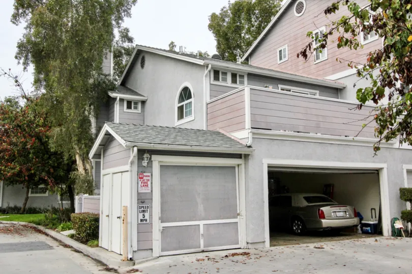 THIS IMAGE VIEWS THE HOUSE WITH CAR SHED NEARBY ROAD WITH PLANTS, TREES ARE THERE IN BUENA PARK