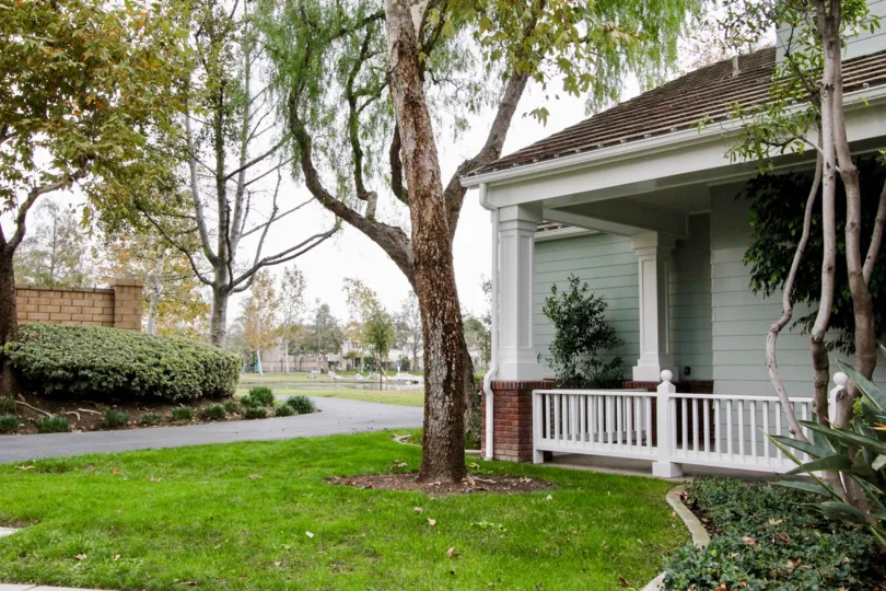 Front to the House in Westshore Villas has meadows with tall trees and plants side to it