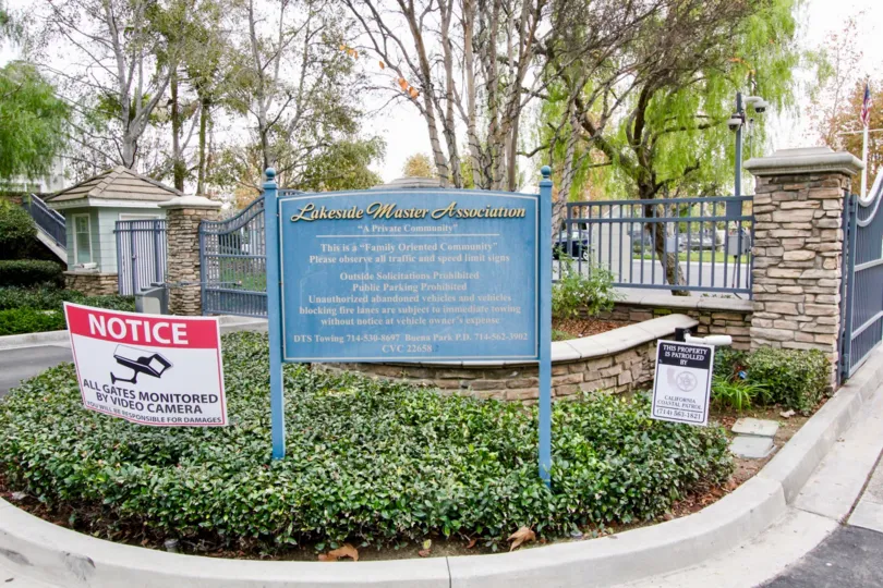 Fabulous view of green garden with trees having notice boards in Westshore Villas of Buena Park