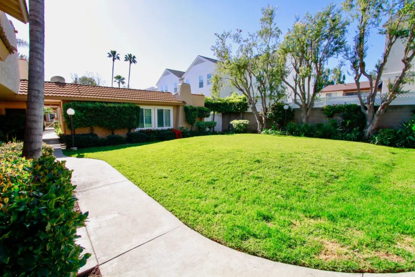 A HOUSE WITH BEAUTIFUL GARDEN AND GRASS IN FRONT OF THE HOUSE AT THE MORNING SUNSHINE TIME.