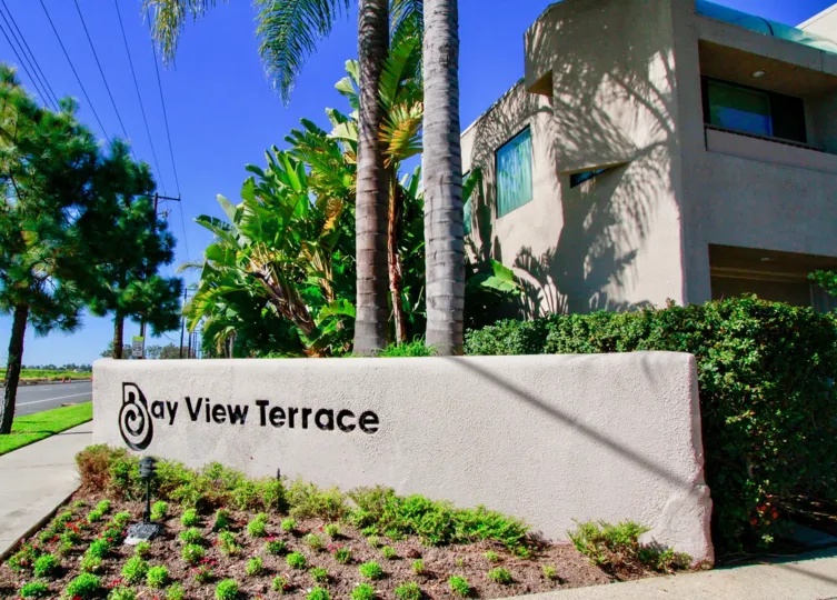 THE BUILDING WITH WINDOWS AND A LONG WALL THAT REPRESENT BAY VIEW TERRACE AND THE WINDOWS OF THE BUILDING ARE CLOSED.