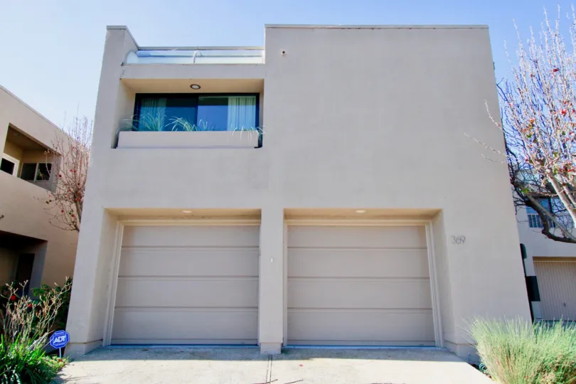 Bay View Terrace two story home with garages and trees on a sunny day.
