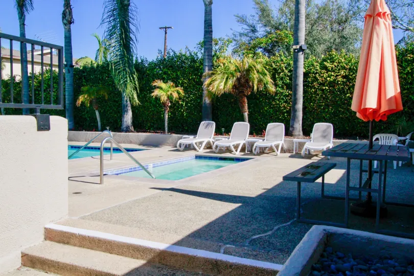 The home in the Bay View Terrace is like a resort with Trees and plants with swimmng pools and tables.