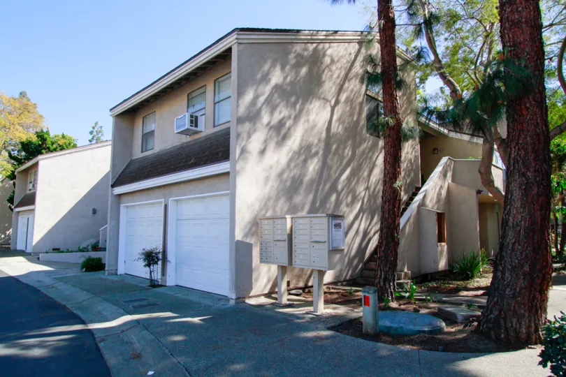 The big houses with ac in the Brighton Springs with big trees and shrubs near the road side with foot path.