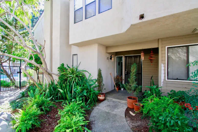 Brighton Springs apartment door with plants and trees