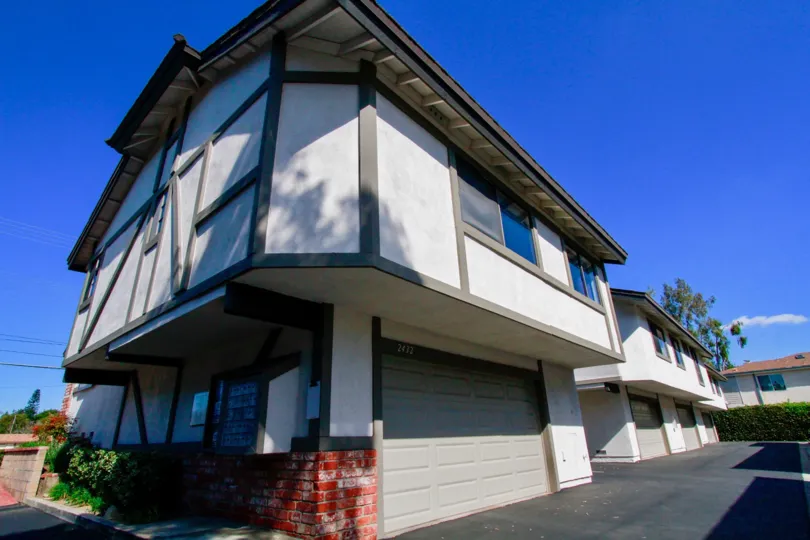 White with brown trim two level town home in Costa Mesa California on a sunny day.