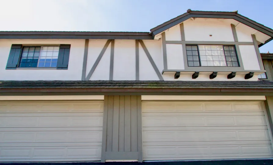 A double door garage with ustairs windows in the Brittanywoods community of Costa Mesa California